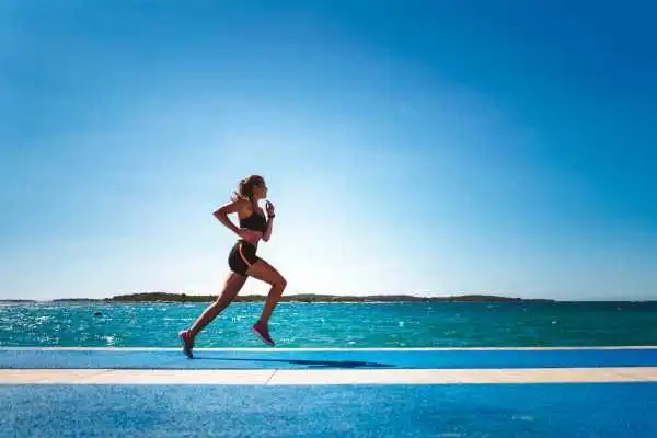 Woman running showing strong leg muscle Herefordshire